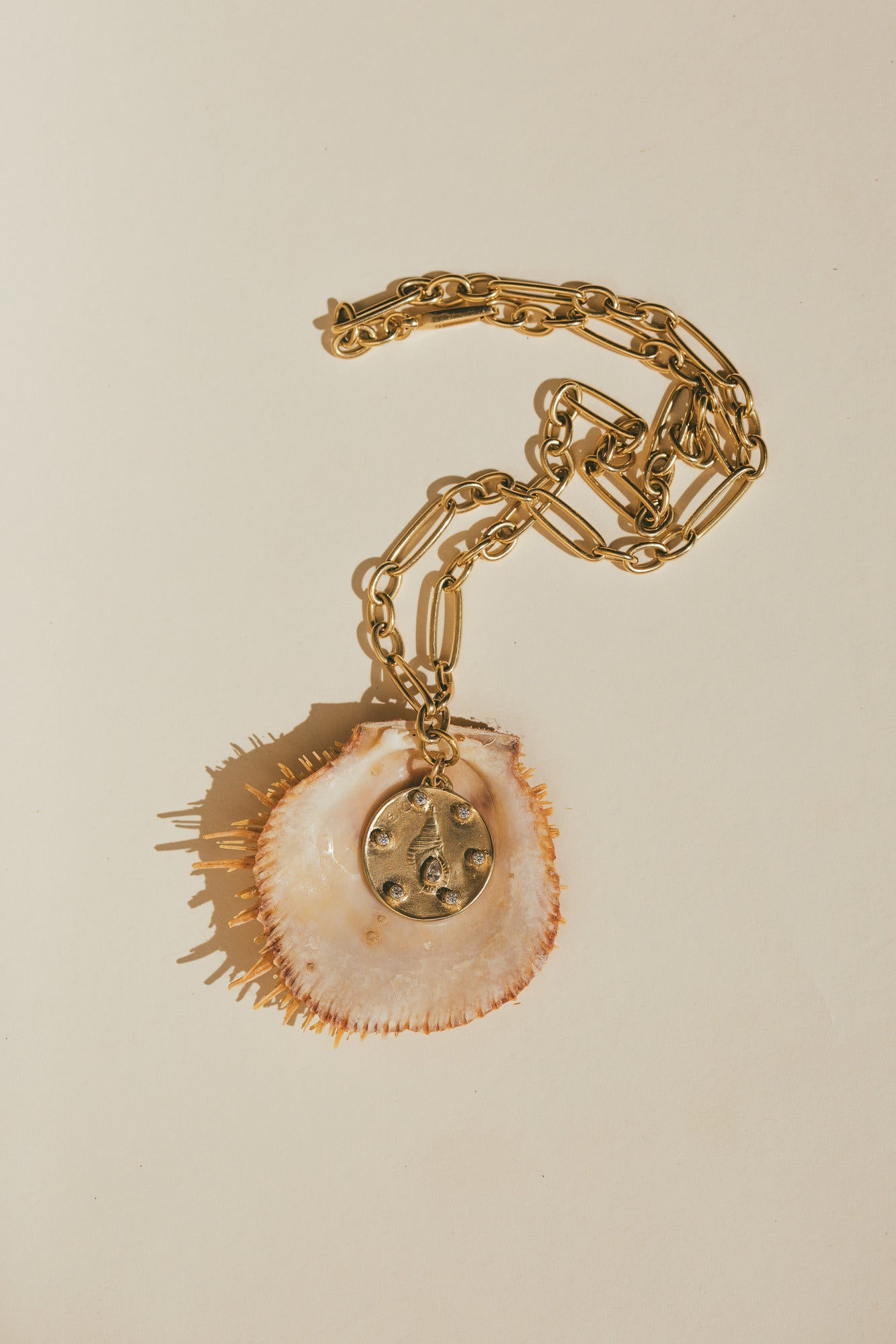 THE LARGE GOLD HORN SHELL CHARM  WITH DIAMONDS ON A SPIKEY SEA SHELL